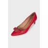Red leather shoes decorated with a bow