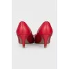 Red leather shoes decorated with a bow