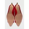 Red leather shoes decorated with a bow