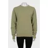 Green sweatshirt with a signature print