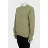 Green sweatshirt with a signature print
