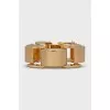 A chunky gold bracelet with a tag
