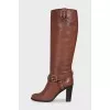 Brown boots decorated with a strap
