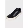 Leather sneakers with a logo on the front