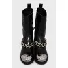 Patent leather boots decorated with a chain