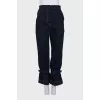 Dark blue jeans decorated with straps