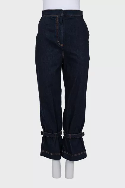 Dark blue jeans decorated with straps