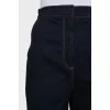 Dark blue jeans decorated with straps