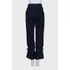 Dark blue jeans decorated with straps