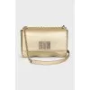 A gold leather bag decorated with crystals