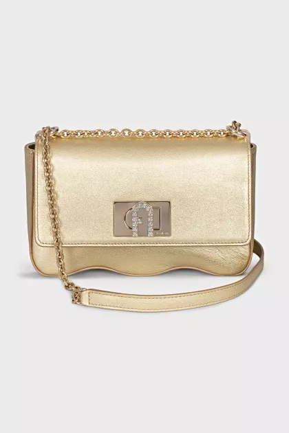 A gold leather bag decorated with crystals