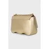 A gold leather bag decorated with crystals