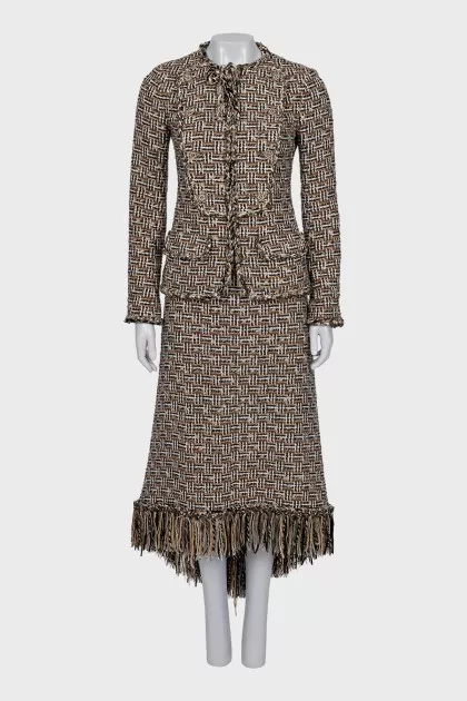 A suit consisting of a zipped jacket and a skirt