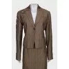 Suit consisting of a jacket with decor and a skirt