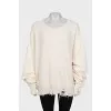 Knitted sweater with a ripped effect