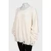 Knitted sweater with a ripped effect