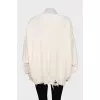 Knitted sweater with a ripped effect