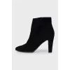 Black suede ankle boots with a zipper
