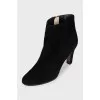 Black suede ankle boots with a zipper