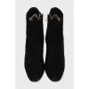 Black suede ankle boots with a zipper