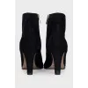 Black suede ankle boots with a zipper