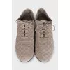 Suede shoes with embossed logo