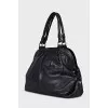 Leather bag with signature clochette