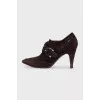 Suede ankle boots with a gold buckle