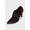Suede ankle boots with a gold buckle