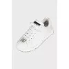 White sneakers with a silver logo