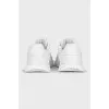White sneakers with a silver logo