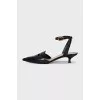 Leather slingbacks with gold-tone clasps