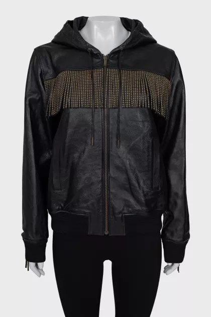 The leather jacket is decorated with fringe and a tag.