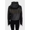 The leather jacket is decorated with fringe and a tag.