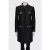 The black coat is decorated with a golden logo.