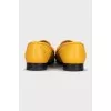 Yellow loafers with gold decor