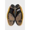 Yellow loafers with gold decor