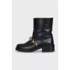 Leather boots with gold-tone decor on the front