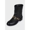 Leather boots with gold-tone decor on the front