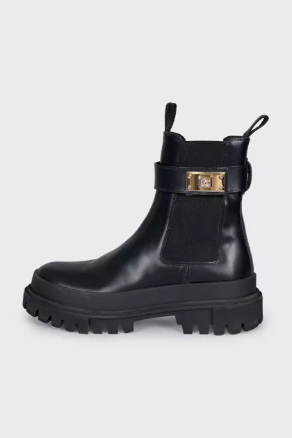 Leather boots with a gold buckle