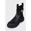 Leather boots with a gold buckle