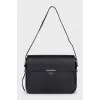 Leather shoulder bag with tag