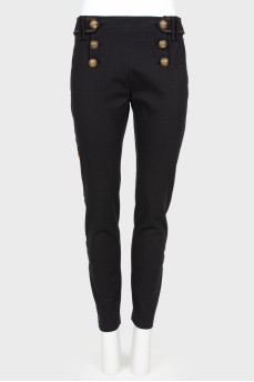 Pants with textured buttons and tag
