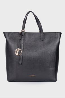 Leather bag with branded accessory