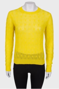 Translucent yellow sweater with a tag