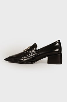 Black loafers with brand logo