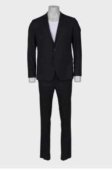 Men's classic suit in a cage with a tag