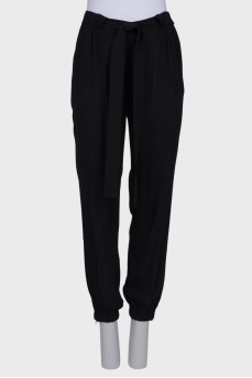 Black trousers with a bow at the waist
