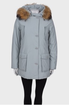 Light gray parka with fur on the hood with a tag