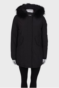 Black parka with fur on the hood with a tag